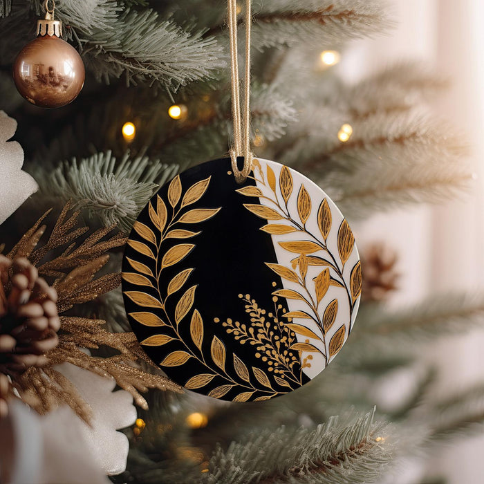 a black and gold ornament hanging from a christmas tree