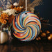 a colorful swirl ornament hanging from a string