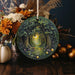 a ceramic ornament with a picture of a forest