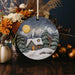 a christmas ornament with a house in the snow