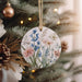 a ceramic ornament hanging from a christmas tree