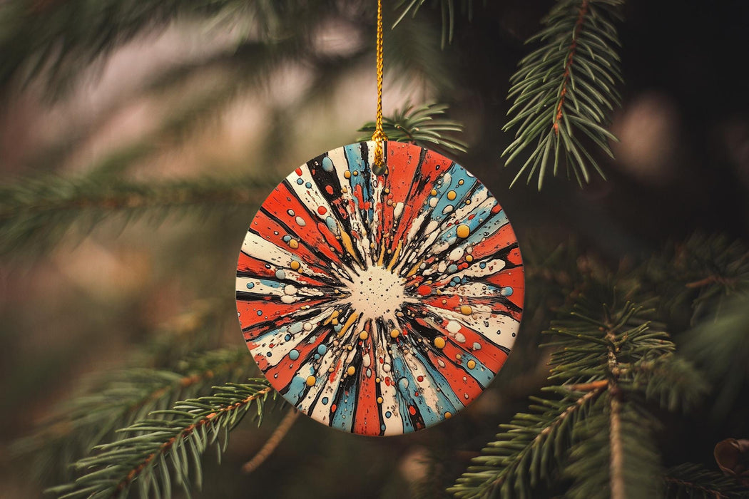 a red, white, and blue ornament hanging from a christmas tree