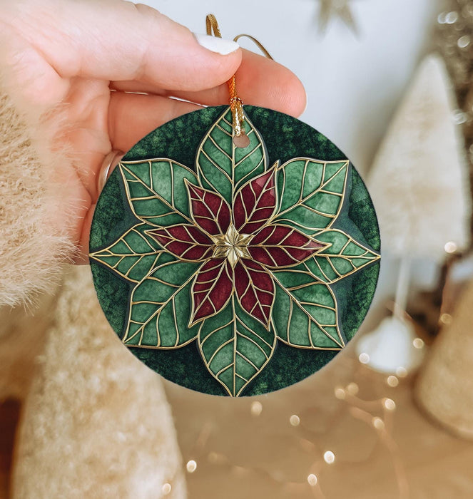 a person holding a christmas ornament in their hand