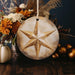 a star ornament sitting on top of a wooden table