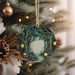 a christmas ornament hanging from a christmas tree