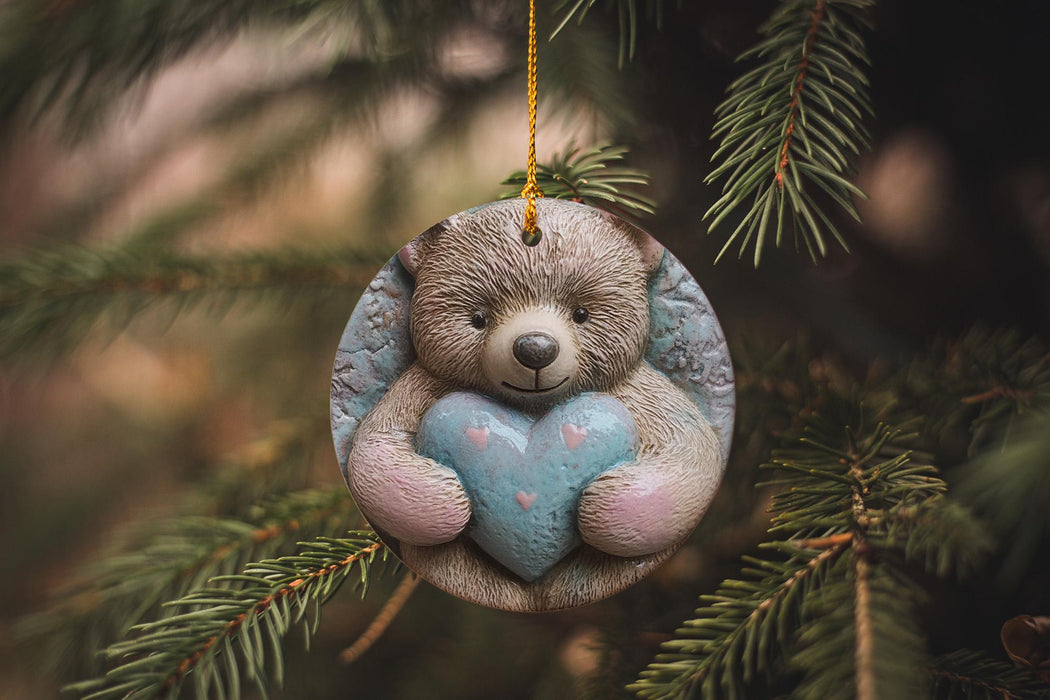 a teddy bear ornament hanging from a christmas tree