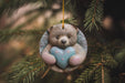 a teddy bear ornament hanging from a christmas tree