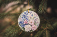 a ceramic ornament hanging from a pine tree