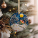 a christmas ornament hanging from a christmas tree