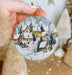 a person holding a christmas ornament in their hand