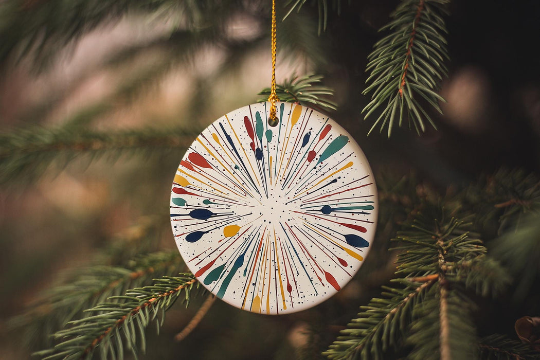 a christmas ornament hanging from a pine tree