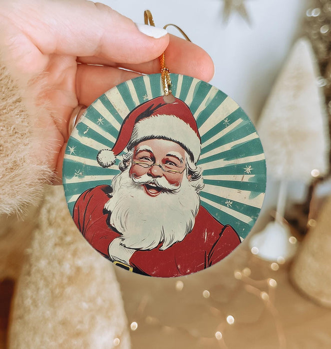 a person holding a christmas ornament with a santa clause on it