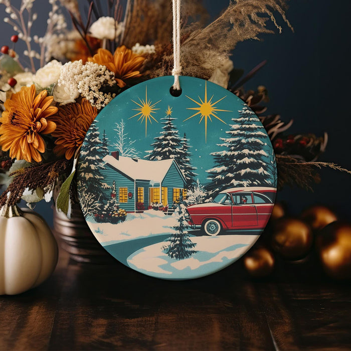 a christmas ornament with a red car in front of a house