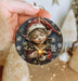a person holding a christmas ornament in their hand