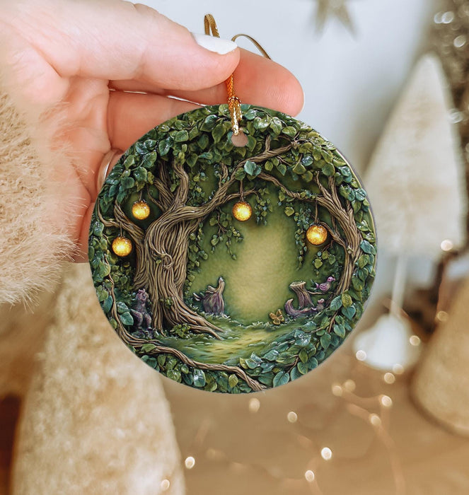 a hand holding a christmas ornament with a tree