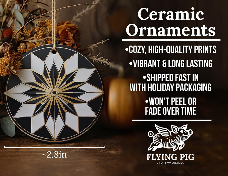 a black and white ceramic ornament next to a pumpkin
