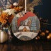 a wooden ornament with a picture of a house on it