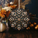 a snowflake ornament sitting on top of a wooden table