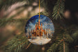 a glass ornament hanging from a christmas tree