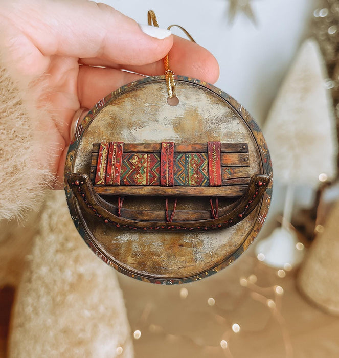 a person holding a wooden ornament with books on it