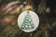 a glass ornament hanging from a christmas tree