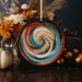 a colorful plate sitting on top of a wooden table