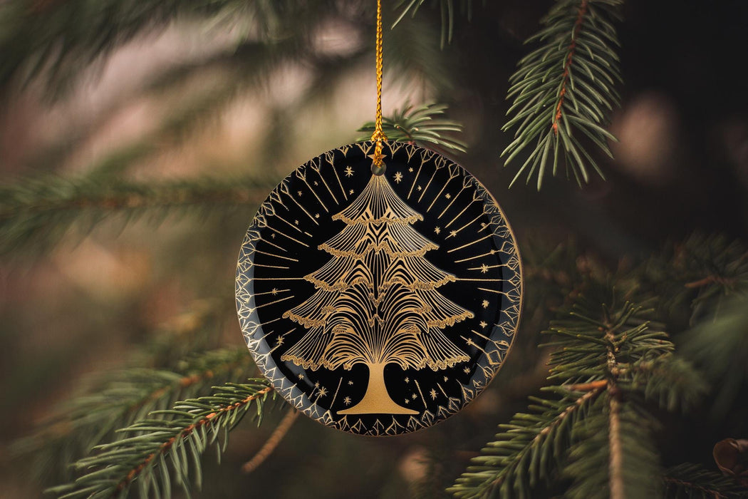 a christmas tree ornament hanging from a pine tree