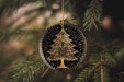 a christmas tree ornament hanging from a pine tree