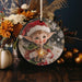 a christmas ornament with a picture of a elf on it