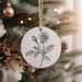 a white ornament hanging from a christmas tree