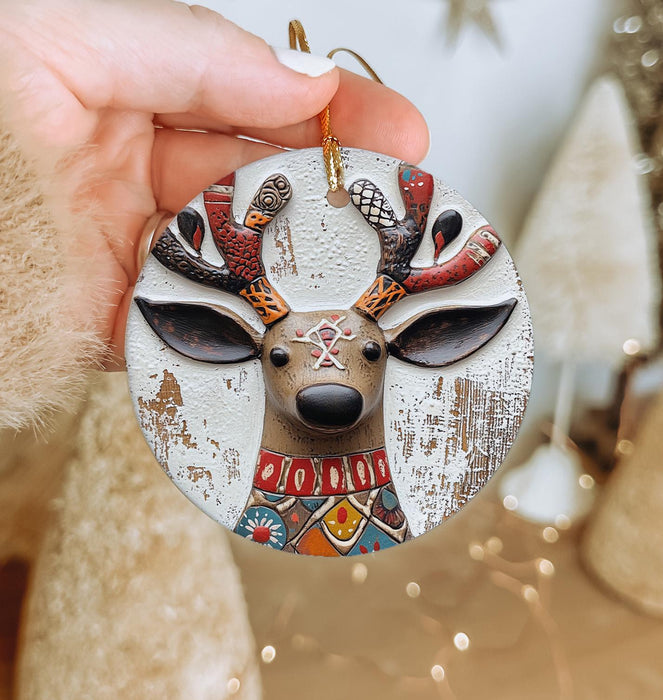 a person holding a christmas ornament in their hand