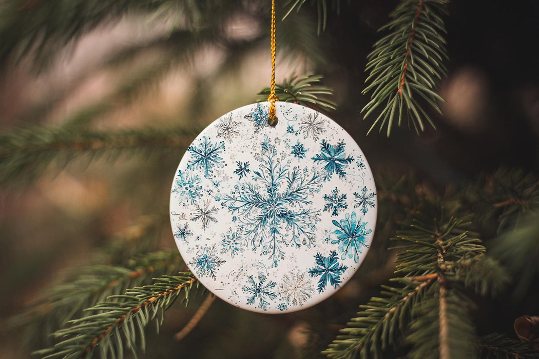 a blue and white ornament hanging from a tree