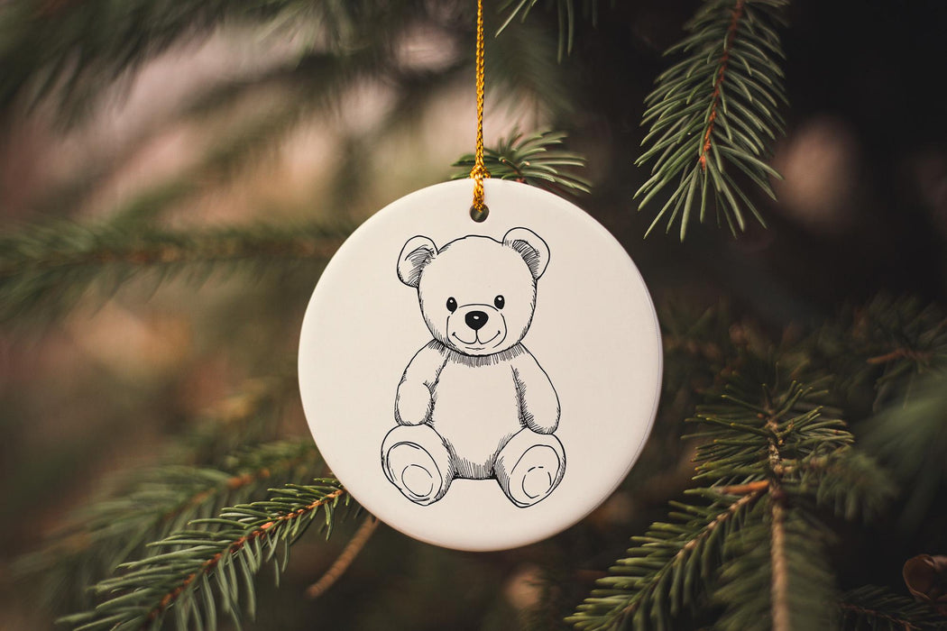 a white ornament hanging from a christmas tree