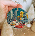 a person holding a christmas ornament in their hand