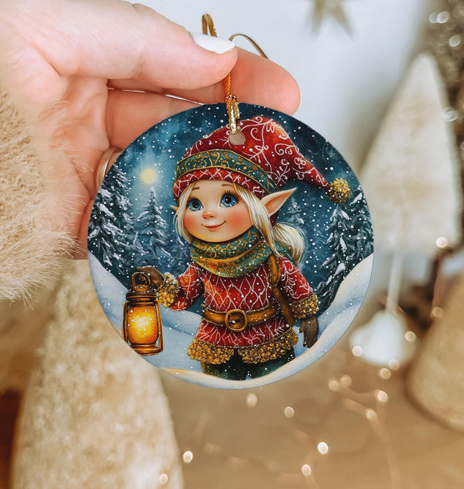 a person holding a christmas ornament in their hand