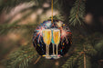 a couple of glasses of champagne hanging from a christmas tree