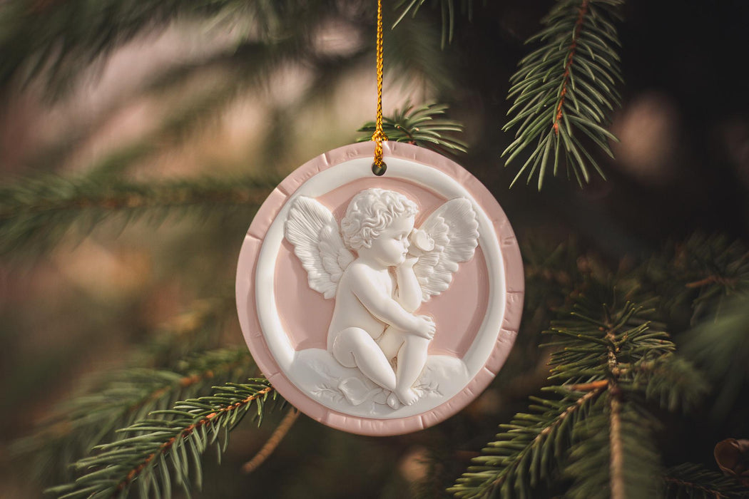 a pink ornament hanging from a christmas tree