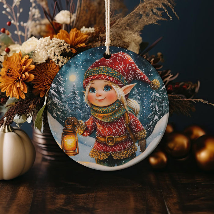 a christmas ornament with a picture of a girl holding a lantern