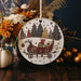 a christmas ornament with a sleigh and trees on it