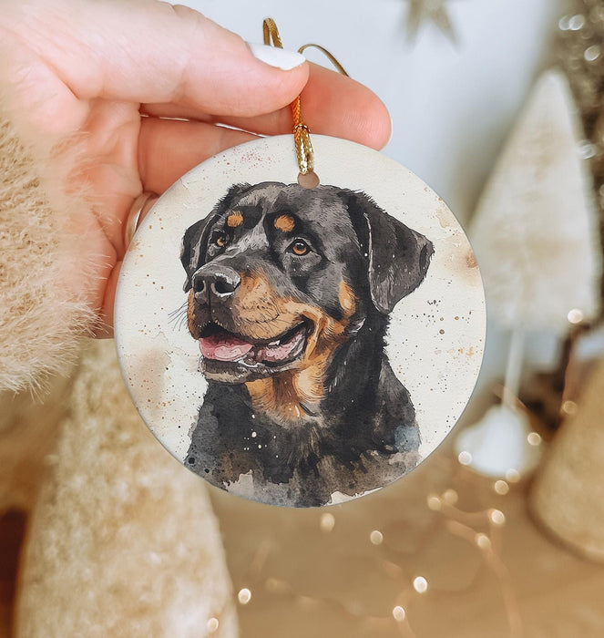 a hand holding a christmas ornament with a picture of a dog
