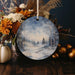 a ceramic ornament with a winter scene on it