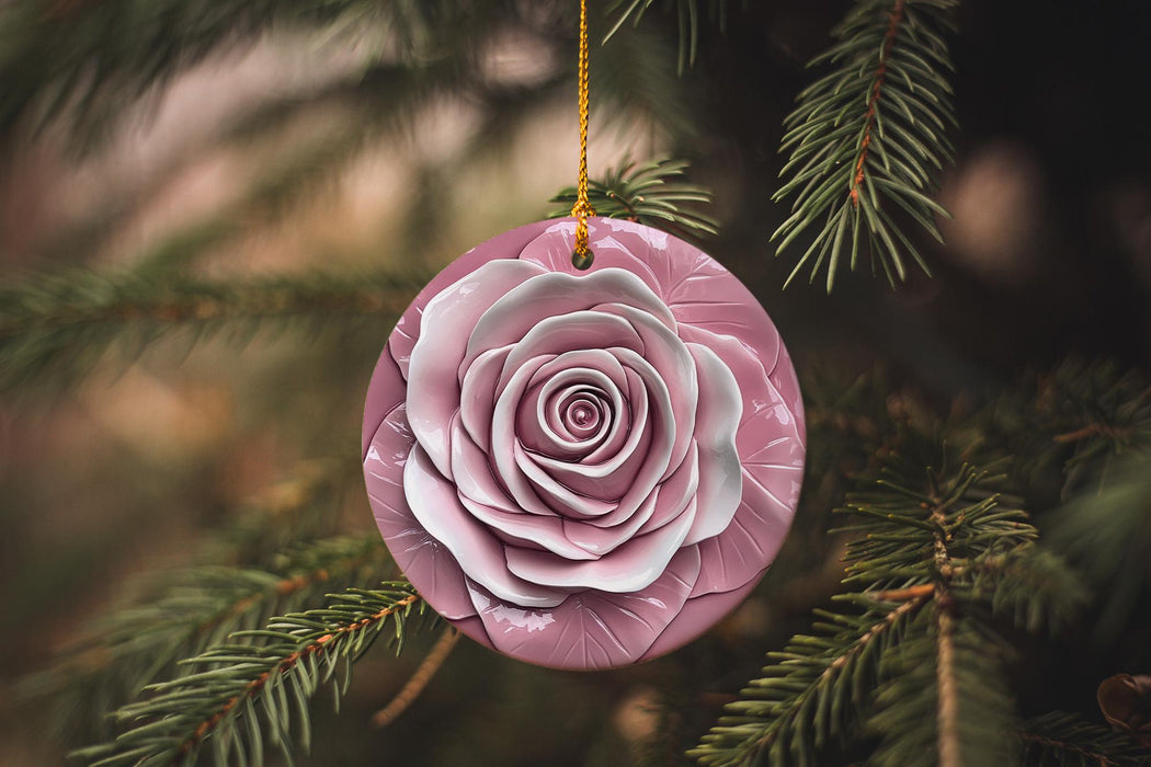 a pink ornament hanging from a pine tree