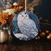 a white owl sitting on top of a wooden table