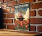 a picture of a windmill on a brick wall