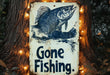 a gone fishing sign hanging on a tree