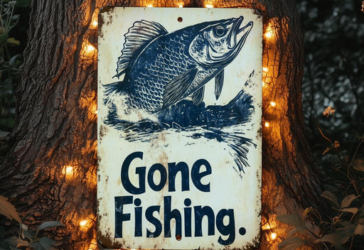 a gone fishing sign hanging on a tree