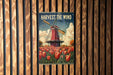 a poster of a windmill in a field of tulips
