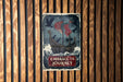 a sign on a wooden wall that says embrace the journey