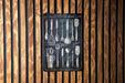 a wooden wall with spoons and measuring spoons on it