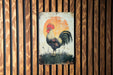 a picture of a rooster on a wooden wall